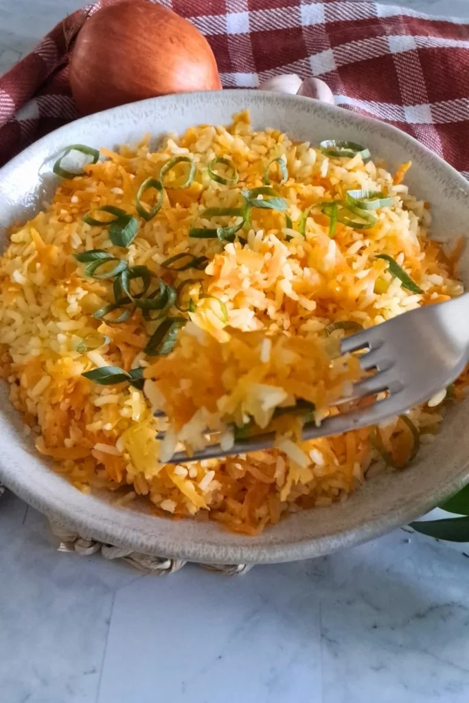 Carrot rice garnished green onions