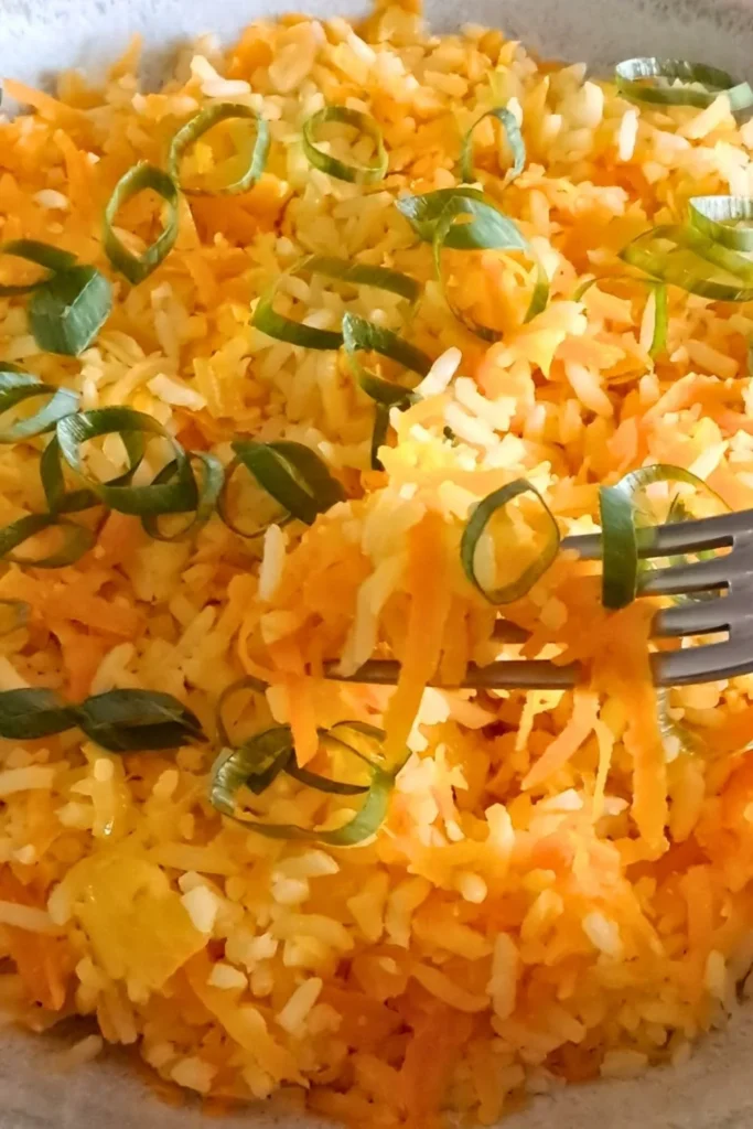 Carrot rice garnished green onions