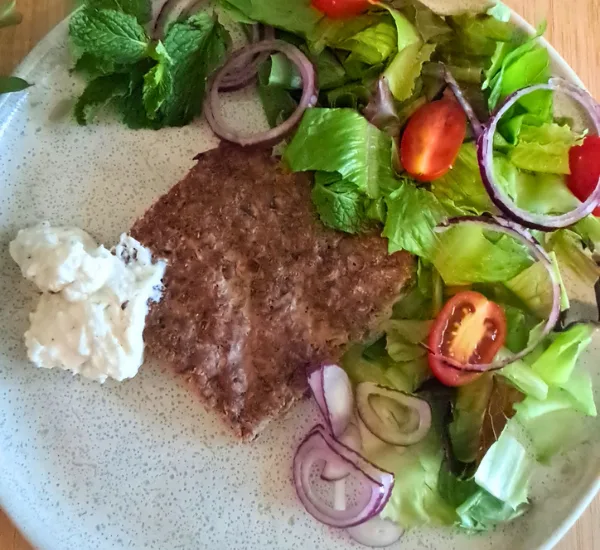 Kafta plated fresh salad herbs